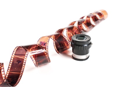 twisted negative film and magnifier isolated on white backgroundの写真素材