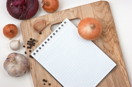 notebook for culinary recipes on a cutting boardの写真素材