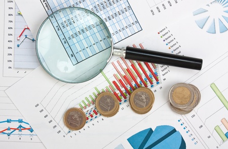 magnifying glass and the working paper with coinssの写真素材