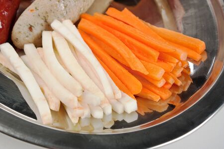 dish of sliced carrots and vegetablesの写真素材