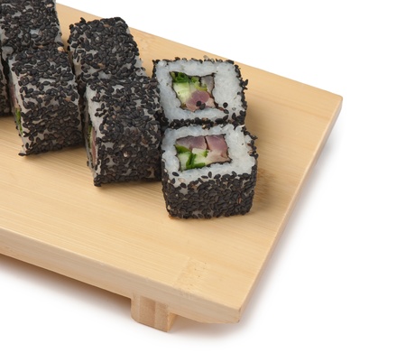 Traditional Asian food sushi on wooden plate isolated on white backgroundの写真素材