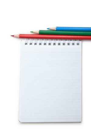 red, green, blue  pencils and notebook  isolated on a white  backgroundの写真素材