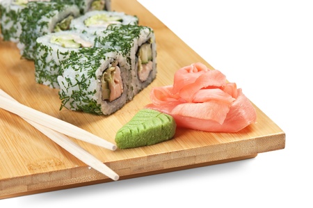 Asian food sushi on wooden plate isolated on white backgroundの写真素材