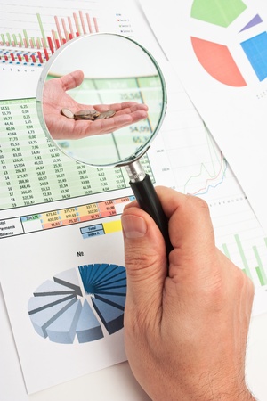 magnifying glass in hand and working paper chartの写真素材