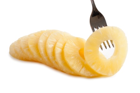 slice of pineapple on a fork  isolated on white backgroundの写真素材