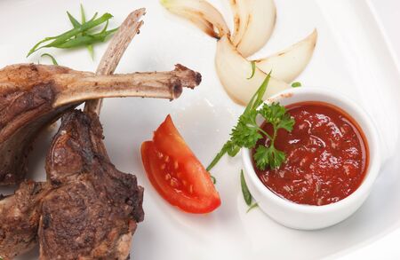 dishes of roast meat with vegetables and spices  isolated on white backgroundの写真素材