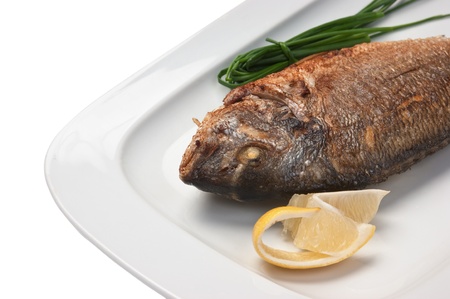 dish of fried fish with onions  isolated on white backgroundの写真素材