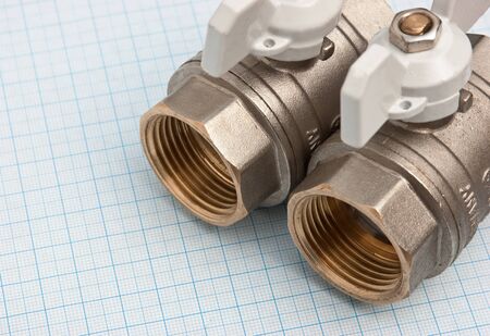 water inlet valve  on a background of graph paperの写真素材