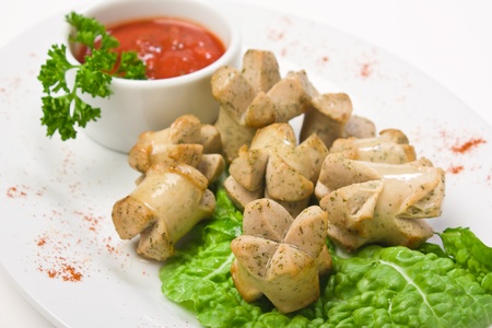 chopped sausages fried with vegetables and spicesの写真素材