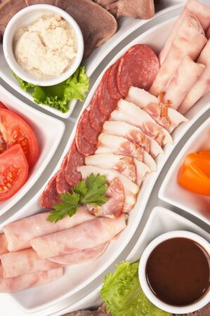 dish of assorted sausages and vegetablesの写真素材
