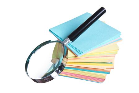 magnifying glass and a stack of paper isolated on a white  backgroundの写真素材
