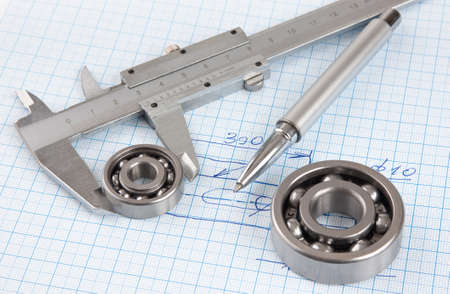 Technical drawing and callipers with  bearing on graph paperの写真素材
