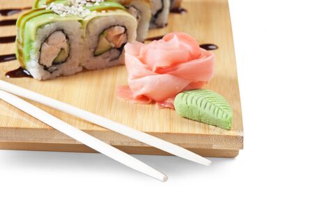 Asian food sushi on wooden plate isolated on white backgroundの写真素材
