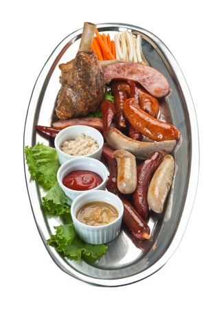 chopped sausages fried with vegetables and spices  isolated on white backgroundの写真素材