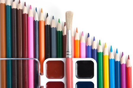 watercolor paints and colored pencils isolated on a white  backgroundの写真素材