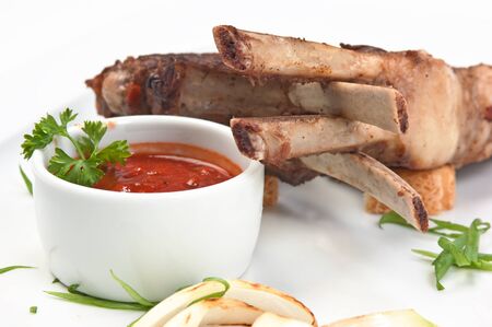 dishes of roast meat with vegetables and spicesの写真素材