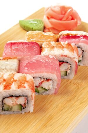 Asian food sushi on wooden plate isolated on white backgroundの写真素材