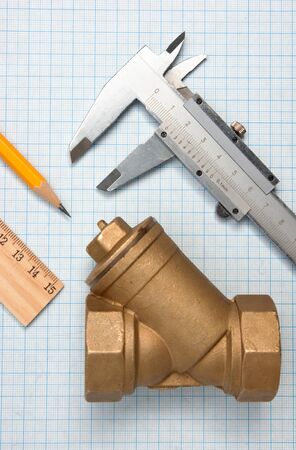 water inlet valve  on a background of graph paperの写真素材