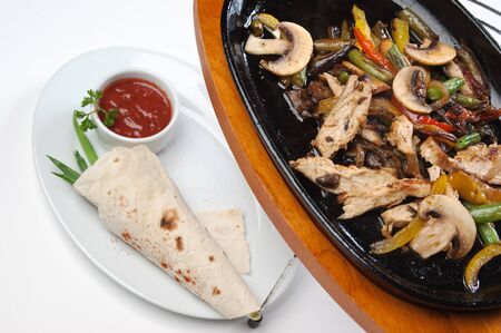 grilled meat with mushrooms and vegetablesの写真素材