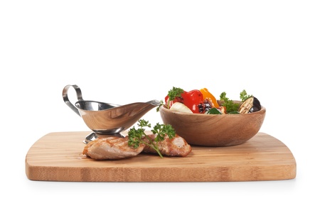 dishes of roast meat with vegetables and spices  isolated on white backgroundの写真素材