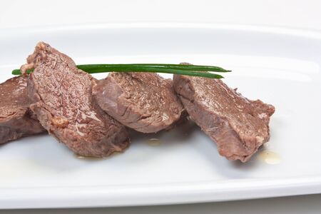 dishes of roast meat with vegetables and spices  isolated on white backgroundの写真素材