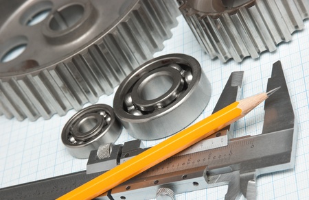 caliper with gears and bearings on graph paperの写真素材