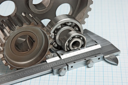 caliper with gears and bearings on graph paperの写真素材