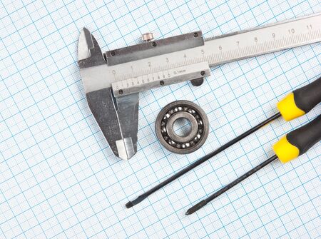 technical tools on a background of graph paperの写真素材