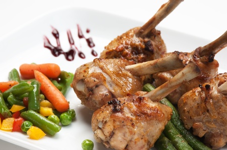 dishes of roast meat with vegetables and spicesの写真素材