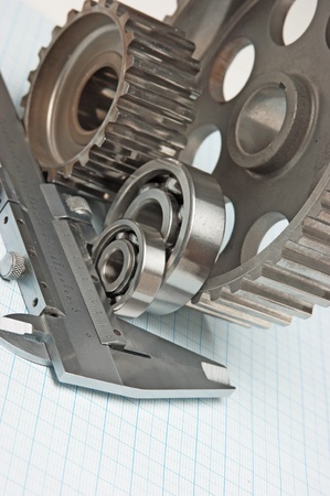 caliper with gears and bearings on graph paperの写真素材