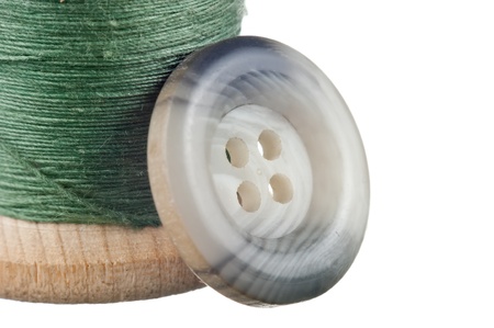 spool of thread and buttons isolated on white backgroundの写真素材