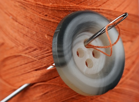 spool of thread and buttons isolated on white background