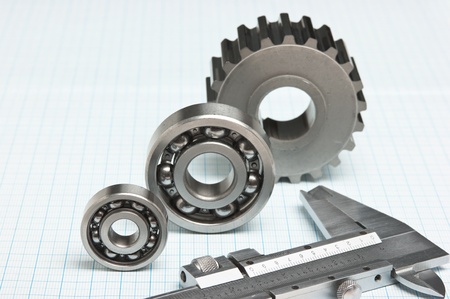 caliper with gears and bearings on graph paperの写真素材