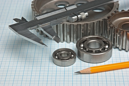 caliper with gears and bearings on graph paperの写真素材