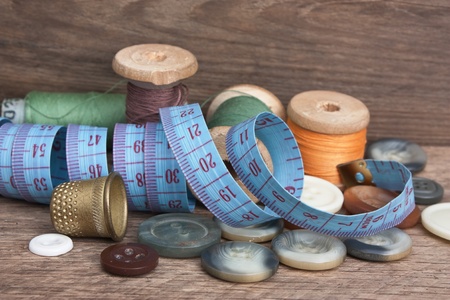 still life of spools of thread on a wooden background