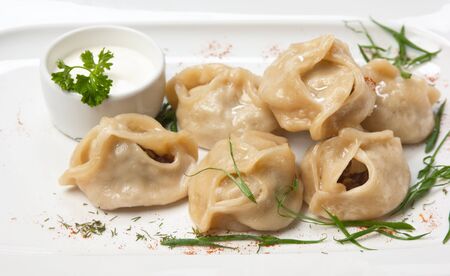 dish of ravioli with sour cream  isolated on white backgroundの写真素材