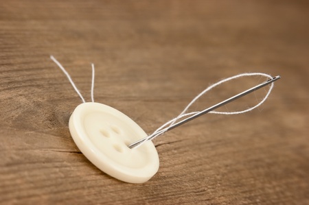 needle and a button on the board