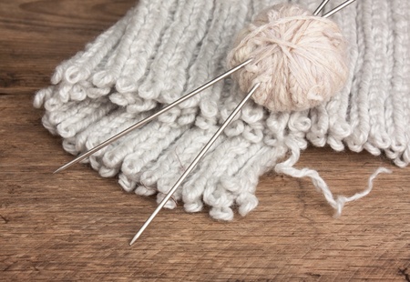ball of wool and knitting needles on a wooden backgroundの写真素材