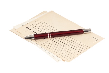 stack of mail envelopes and a pen isolated on white backgroundの写真素材