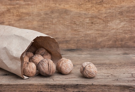walnuts in a brown kraft paper bagの写真素材