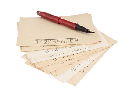 stack of mail envelopes and a pen isolated on white backgroundの写真素材