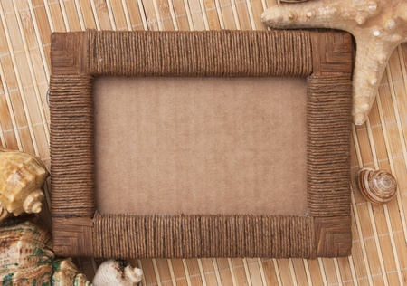 Photo frame of mats and sea shellsの写真素材