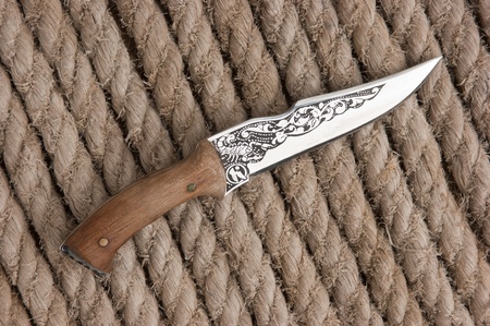 hunting knife on the background of hemp ropeの写真素材