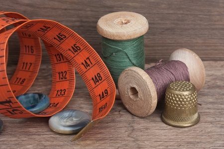 still life of spools of thread on a wooden background
