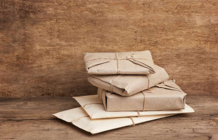 pile parcel wrapped with brown kraft paper and tied with twineの写真素材