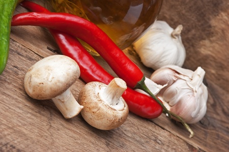 glass bottle with spices and vegetables on a cutting boardの写真素材
