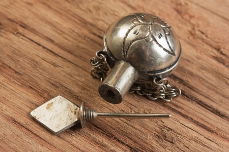 old metal vials for potions on a wooden boardの写真素材