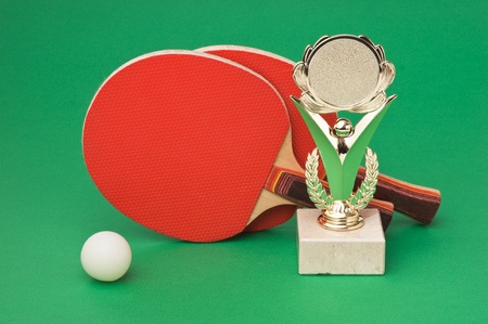 sports awards and  tennis racquets on a green tableの写真素材