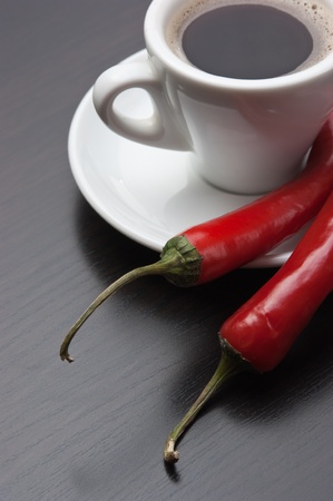coffee cup and red chili peppersの写真素材
