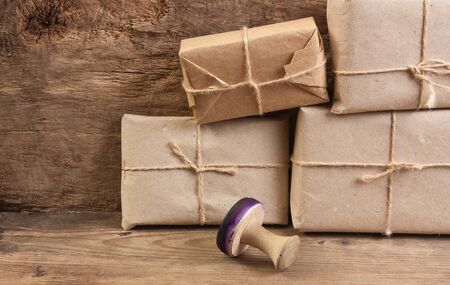pile parcel wrapped with brown kraft paper and tied with twineの写真素材